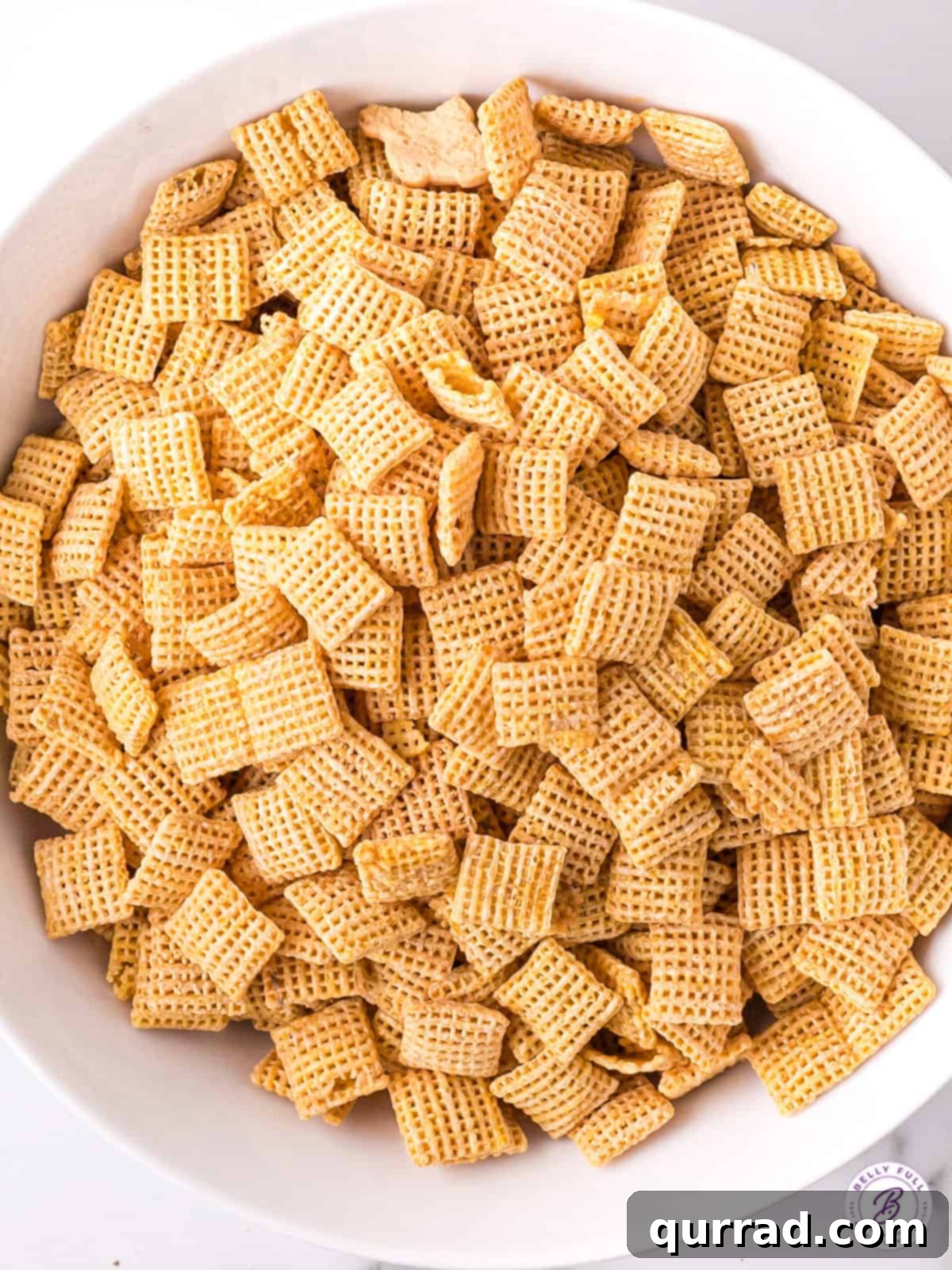 Star-Spangled Snack Mix 3 An overhead view of a bowl filled with crisp Rice Chex cereal, the essential base for delicious muddy buddies.