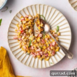 overhead image of corn salad on ornate plate with spoon