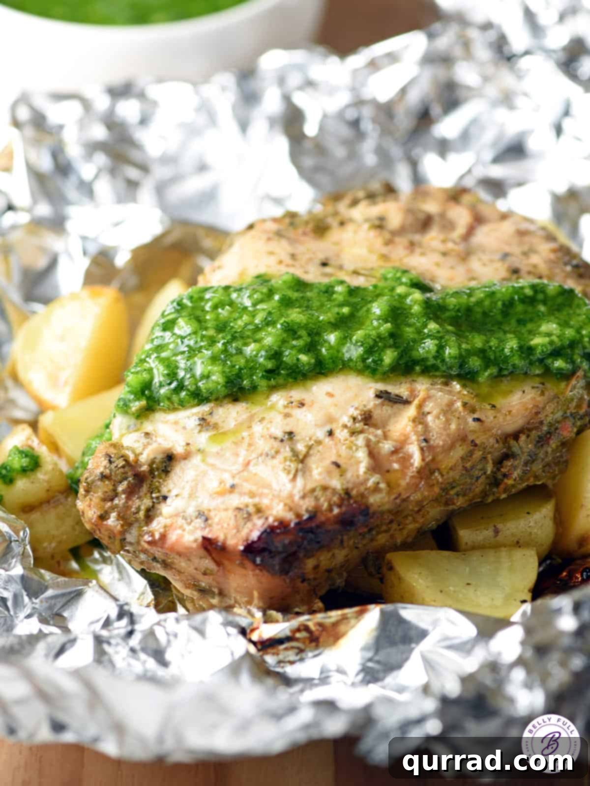 Grilled Pork Chops: Foil Packet Perfection 2 Grilled pork chop topped with fresh, vibrant Chimichurri sauce, showcasing a delicious and easy summer meal.