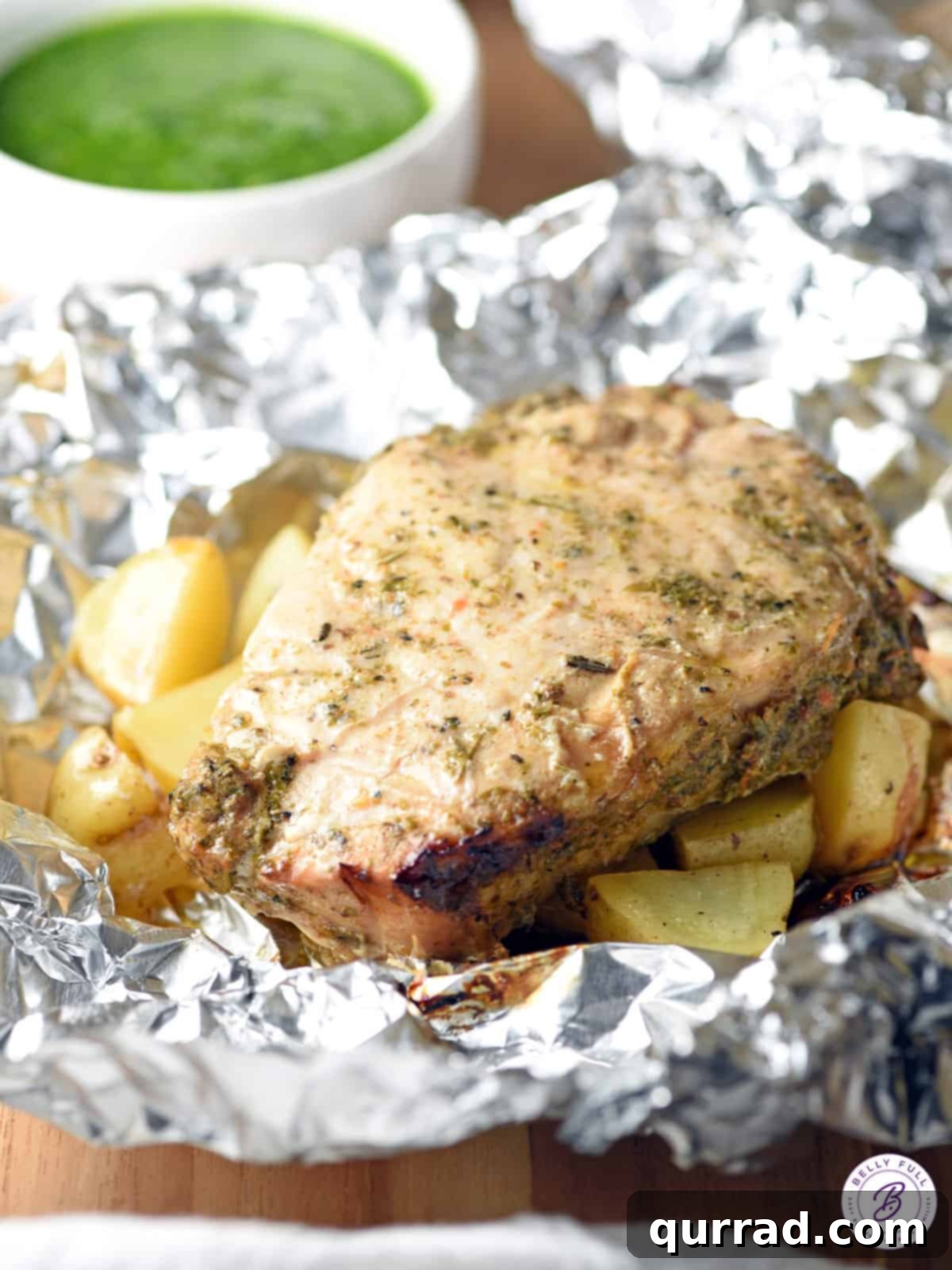Grilled Pork Chops: Foil Packet Perfection 3 Grilled pork chop and potatoes served in foil, a convenient and delicious meal.