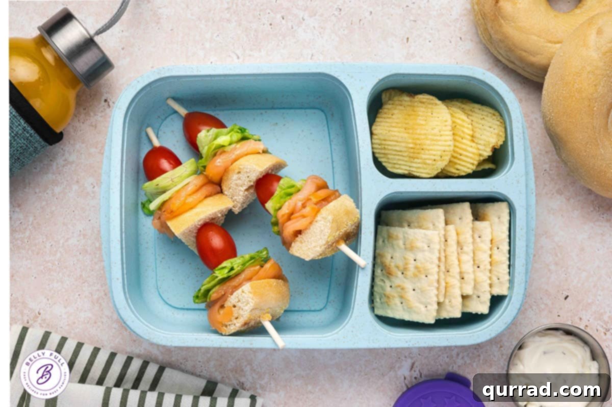 Skewered Sandwich Classics 9 Lox and Bagel on a stick with pieces of bagel, lox, lettuce, and tomato, making for a refreshing and elegant lunch.