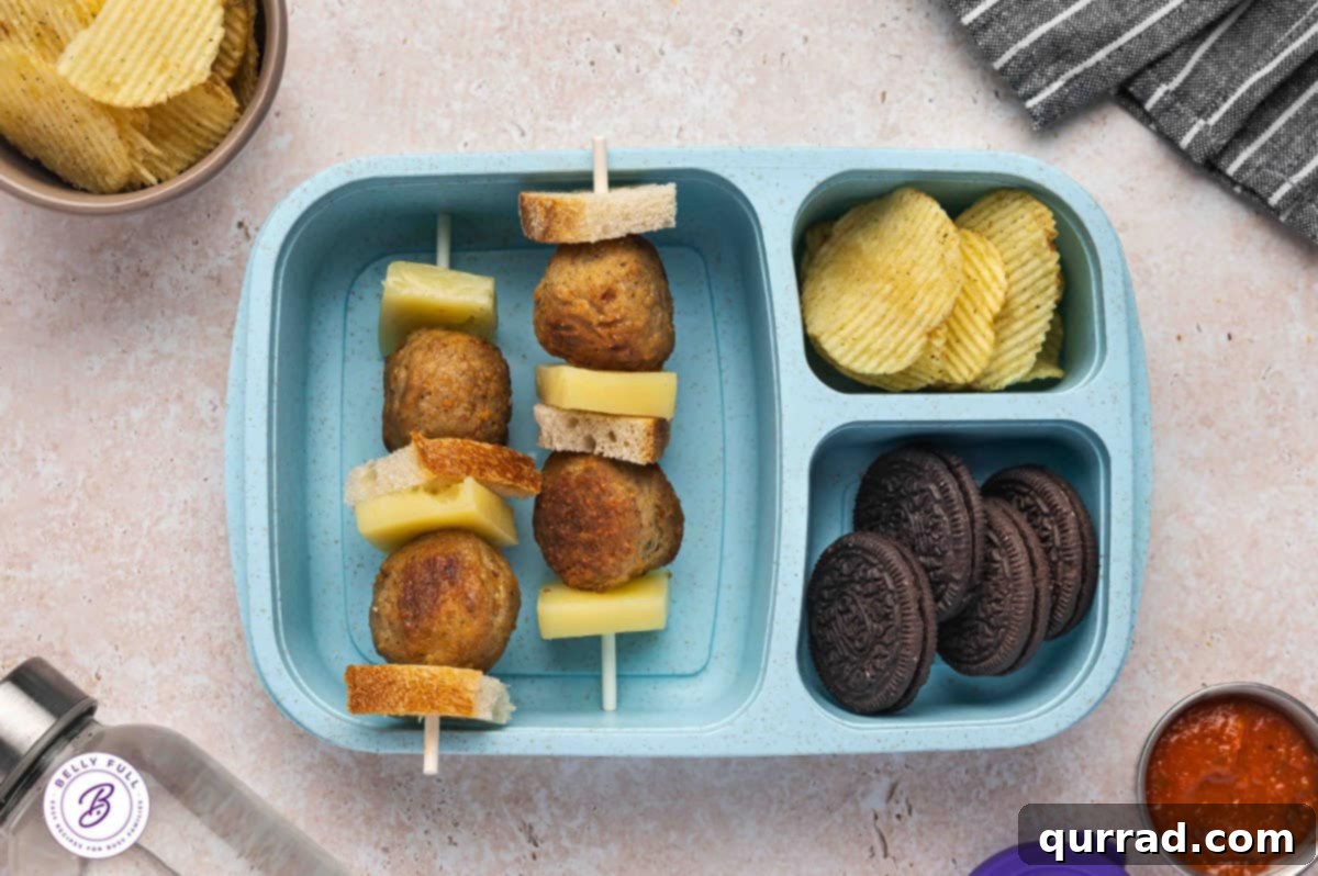 Skewered Sandwich Classics 11 Meatball Sub sandwich on a stick with pieces of sourdough bread, cooked Italian meatballs, and provolone cheese in a lunch box.