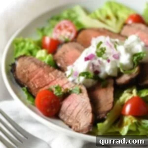 Mediterranean Steak & Greens with Cooling Tzatziki 4 Grilled Steak Salad with Tzatziki Sauce - tender marinated steak is served on top of salad with a light and refreshing yogurt sauce for an easy, low-calorie meal!