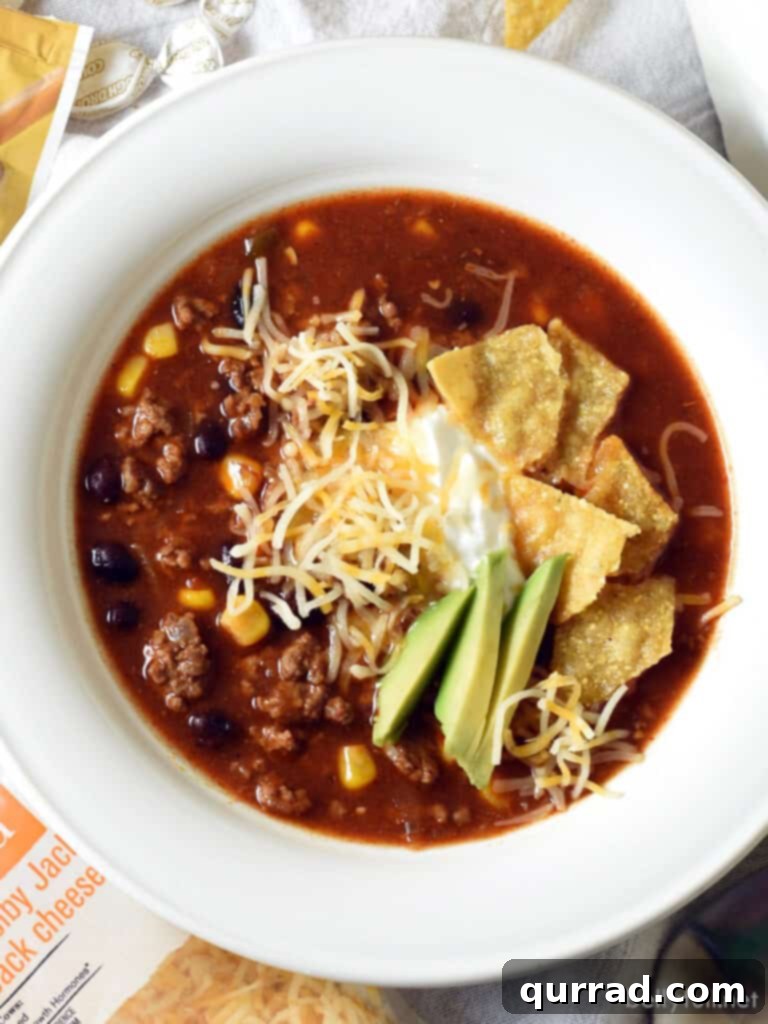 overhead bowl of taco soup garnished with fresh ingredients
