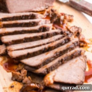 slow cooker beef brisket sliced thin on cutting board
