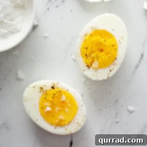 overhead hard boiled egg cut in half sprinkled with salt and pepper