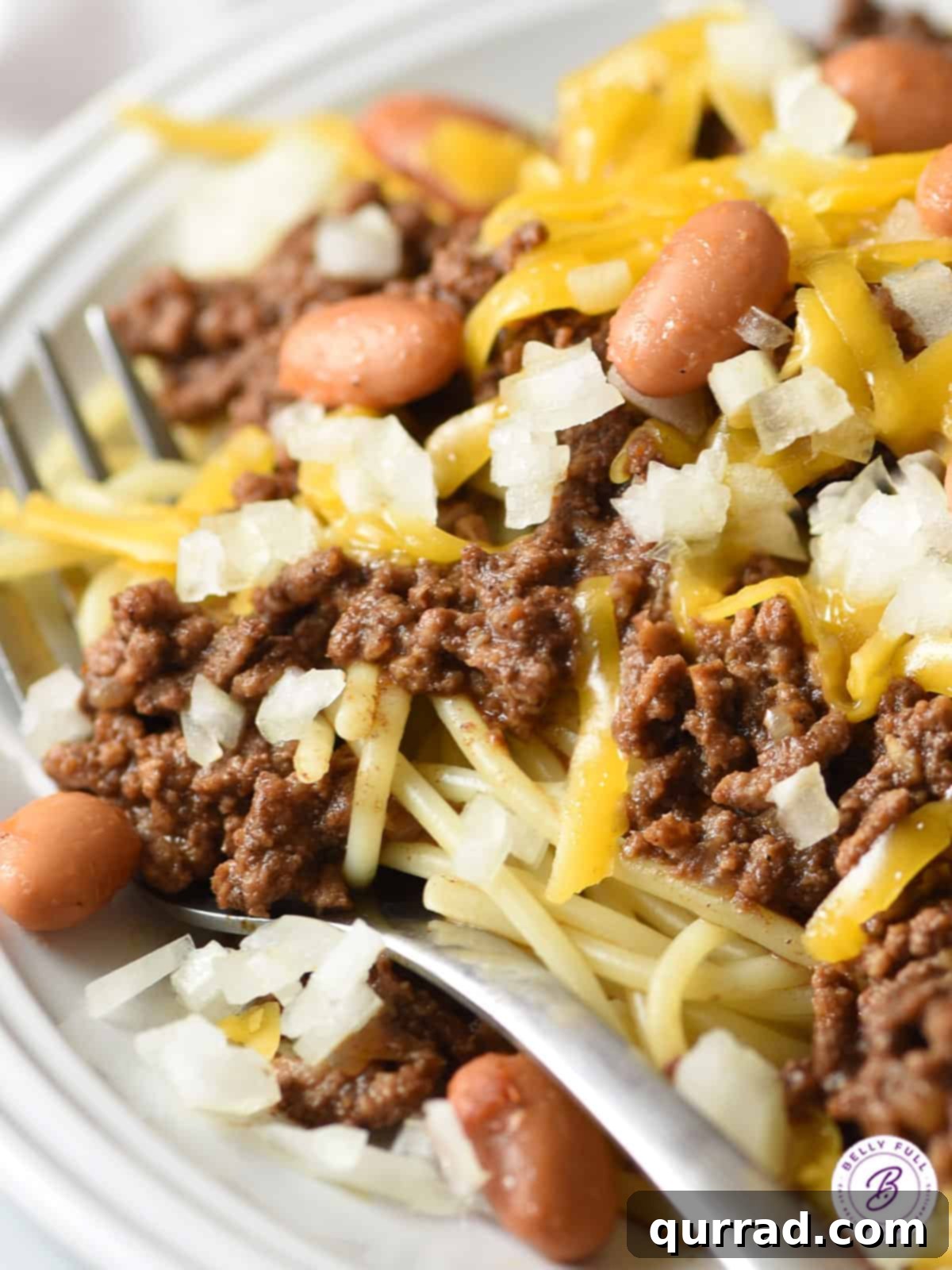 Cincinnati's Signature Chili 4 close up Cincinnati chili on white plate with fork
