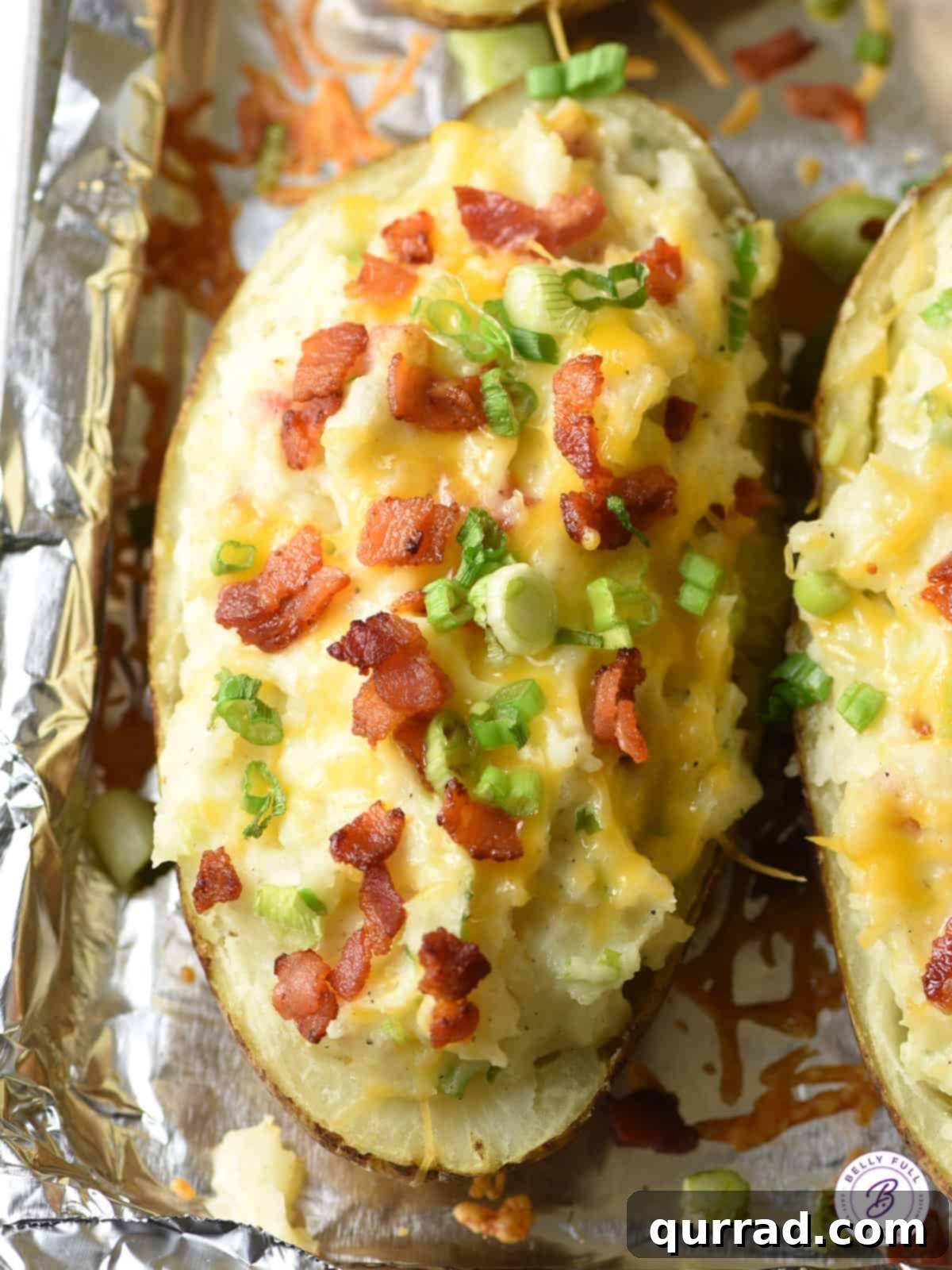 Overhead view of a twice baked potato garnished with abundant bacon crumbles