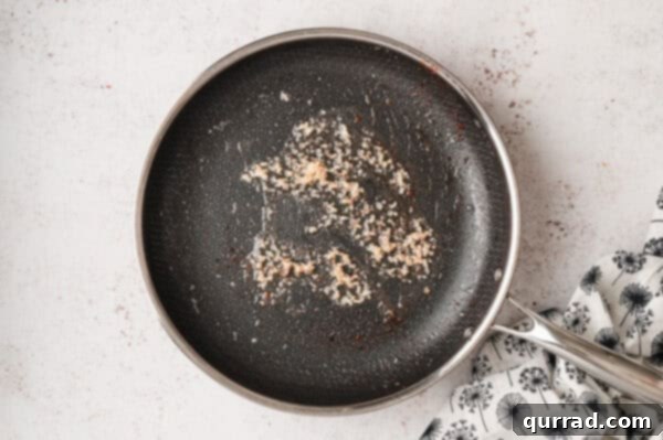 Minced garlic sizzling in olive oil in a skillet
