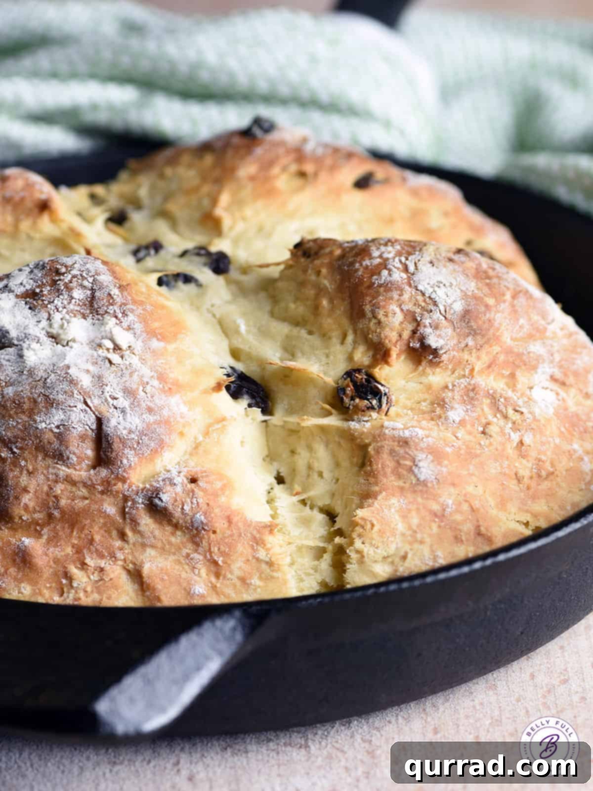 Freshly baked Irish Soda Bread in a cast iron skillet, golden brown and rustic.