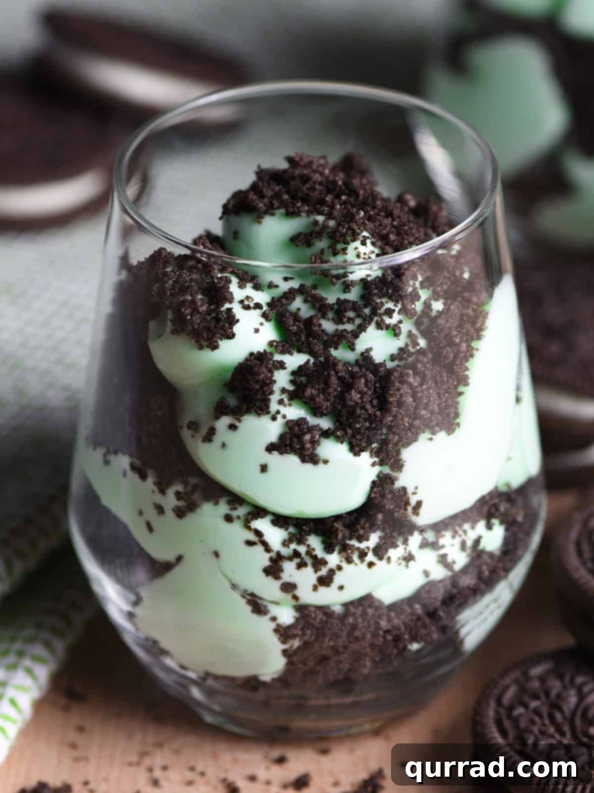 layered crushed mint oreo and whipped cream in glass