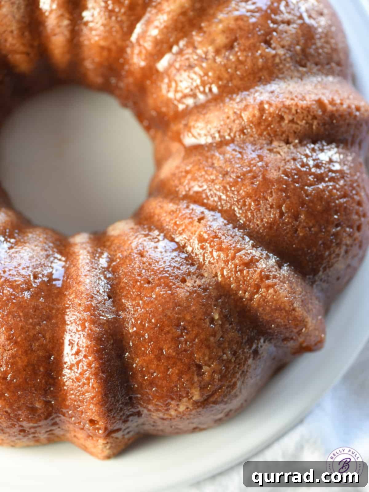 An inviting overhead shot of a spiced Bundt cake, beautifully glazed and presented on a serving plate, ready to be enjoyed.