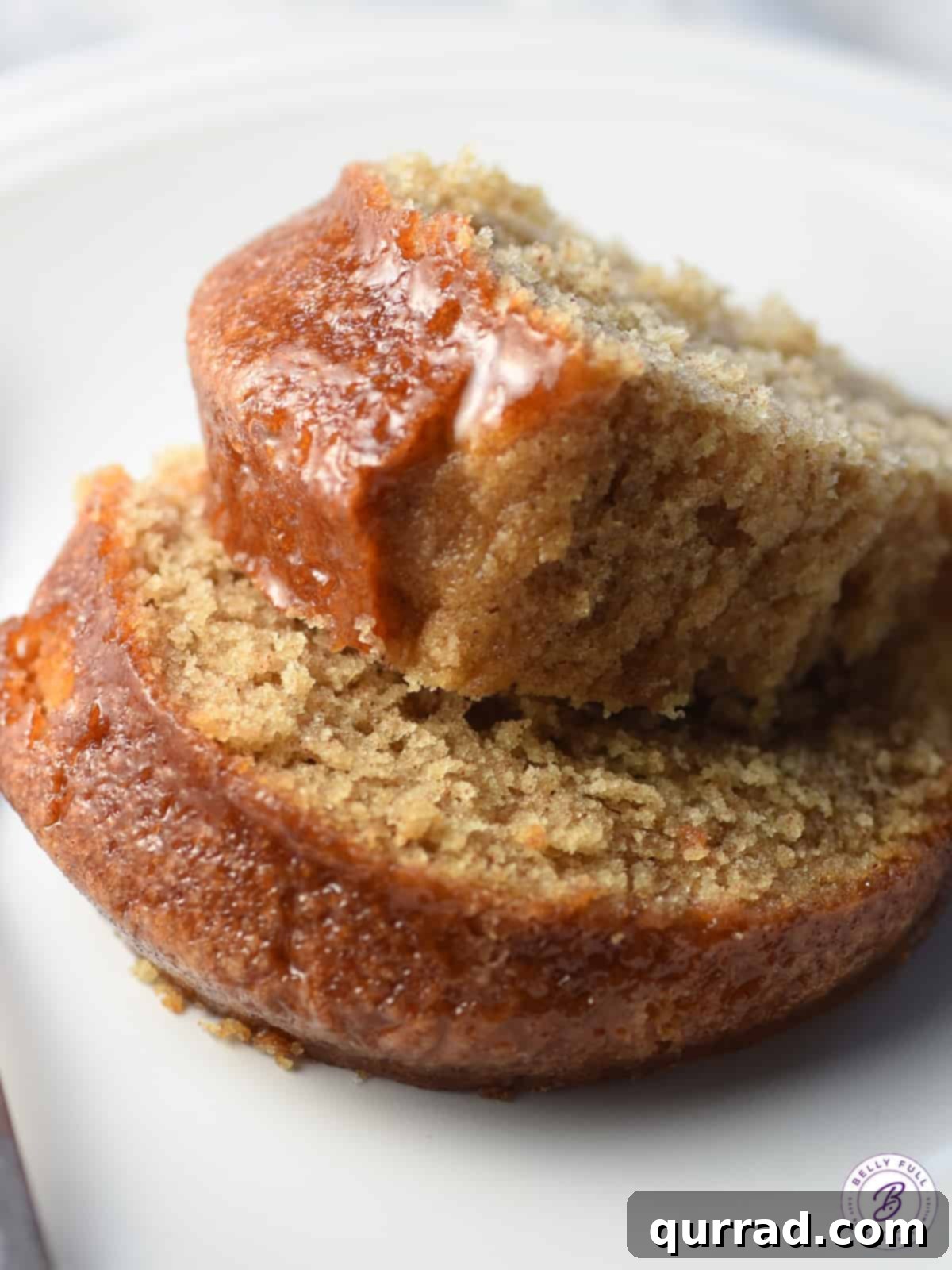 Two enticing slices of perfectly baked cinnamon cake, gracefully stacked and ready to be served.