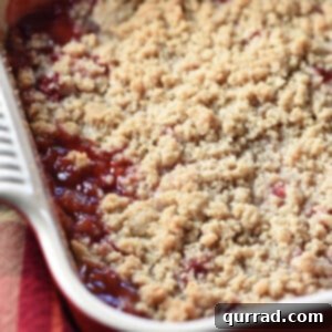 Strawberry Rhubarb Crumble in a white baking dish, fresh from the oven