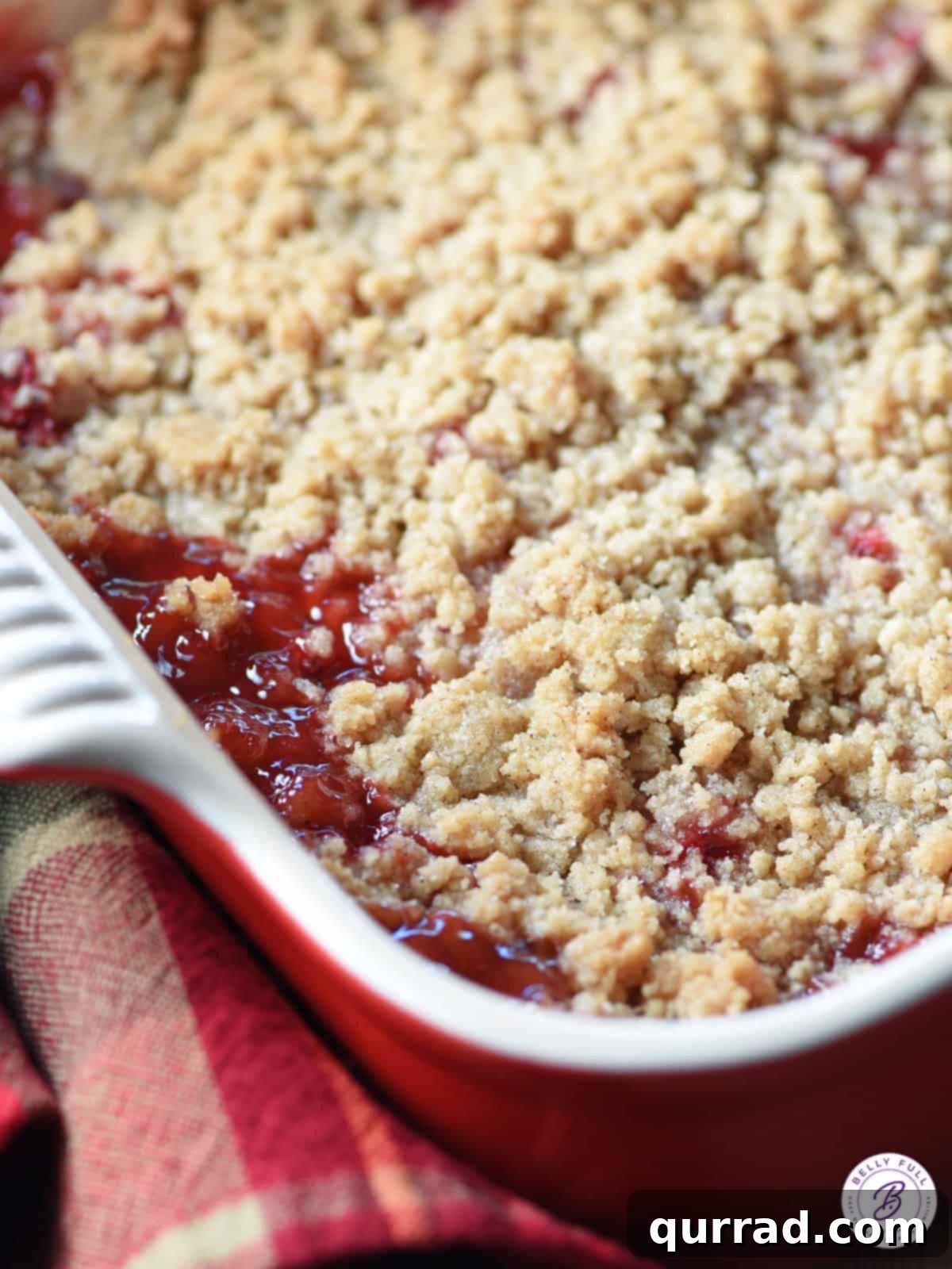 Rustic Strawberry Rhubarb Crumble 5 Close-up of bubbling strawberry rhubarb filling with streusel topping in a baking dish, fresh from the oven