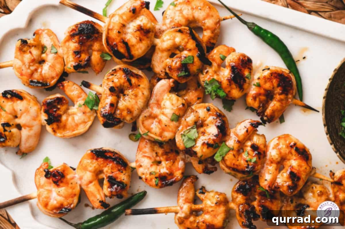 Zesty Thai Grilled Shrimp 10 A close-up of delicious Thai grilled shrimp on a white plate, ready to be enjoyed.