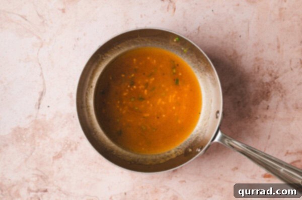 The spicy Thai chile marinade simmering in a small saucepan.