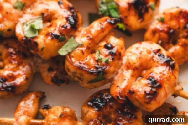 Plated grilled shrimp skewers, garnished and ready to be served.