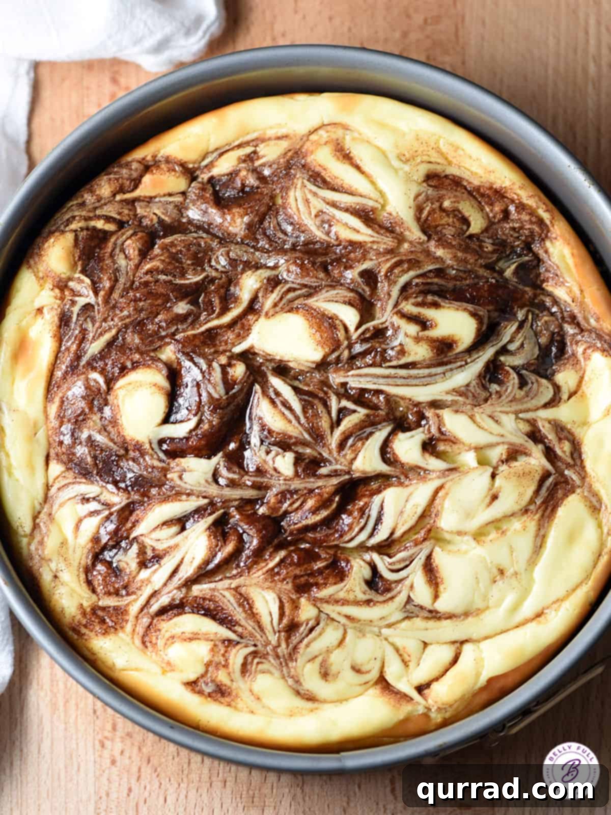 Cinnamon Swirl Cheesecake 2 overhead view of cheesecake with cinnamon swirl, showcasing its beautiful pattern and golden-brown crust