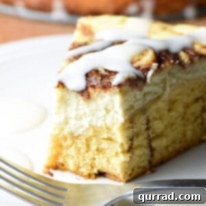 slice of cinnamon roll cheesecake with bite taken