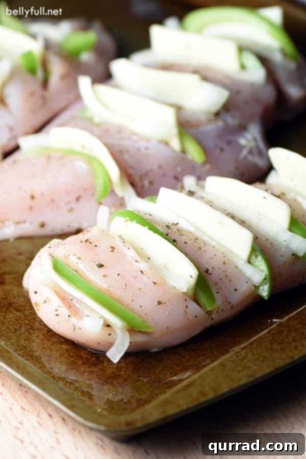 Loaded Hasselback Chicken Philly Cheesesteak 4 Hasselback chicken breast stuffed with provolone cheese, green bell pepper, and thinly sliced onion before baking.