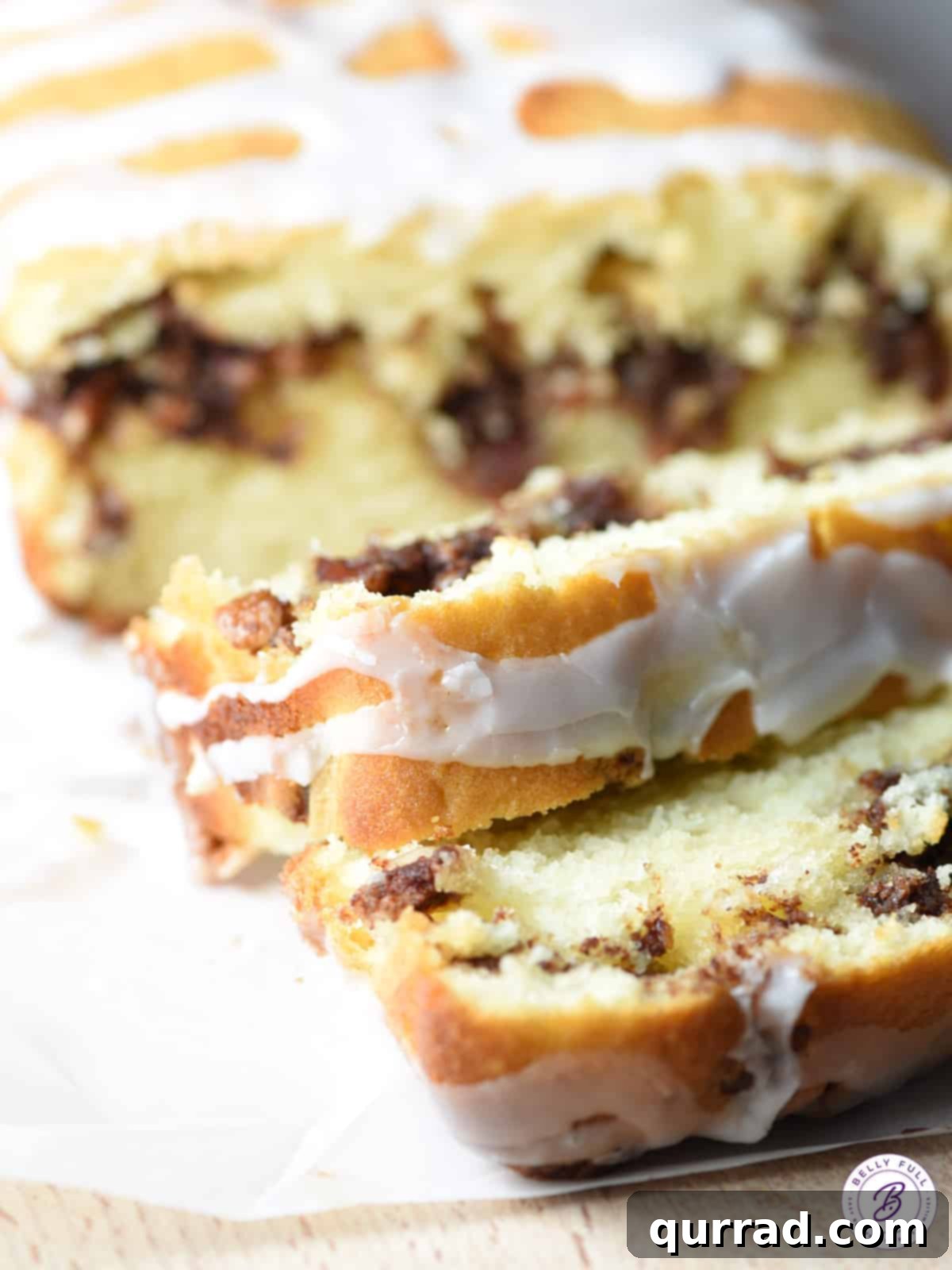 Close up of a slice of cinnamon roll quick bread showing texture and glaze