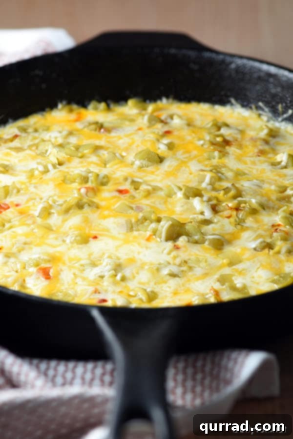 Chile Relleno Dip in a rustic cast iron skillet, ready to be served with tortilla chips