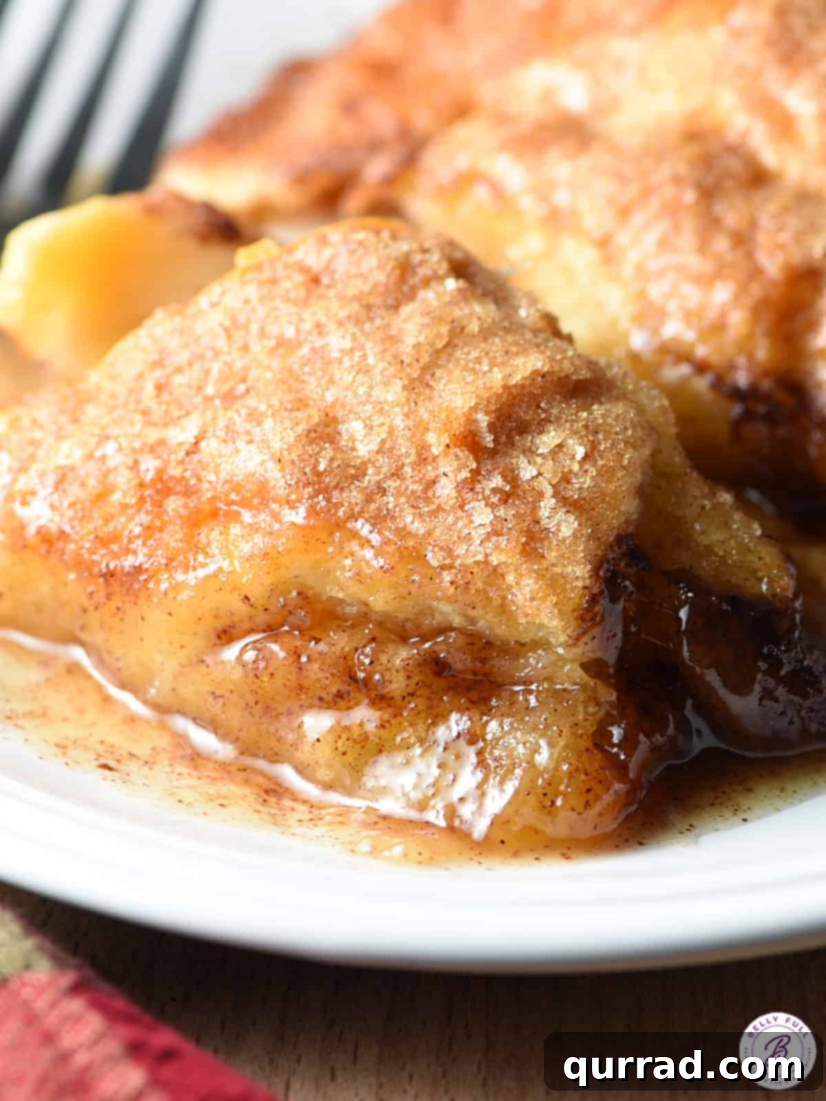 Effortless Baked Apple Bliss 8 Close-up shot of an apple dumpling, revealing the gooey sauce and tender apple inside.
