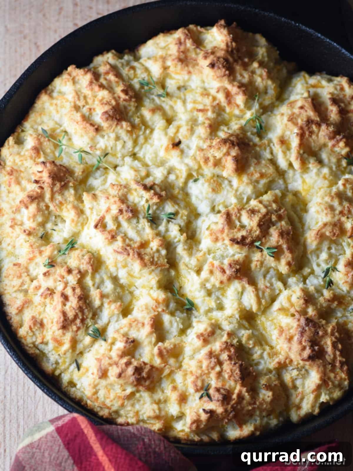 Sweet & Savory Apple-Cheddar Skillet Biscuits 3 Overhead shot of freshly baked drop biscuits nestled in a cast iron skillet.