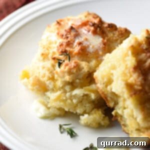 Two apple cheddar drop biscuits with melted butter
