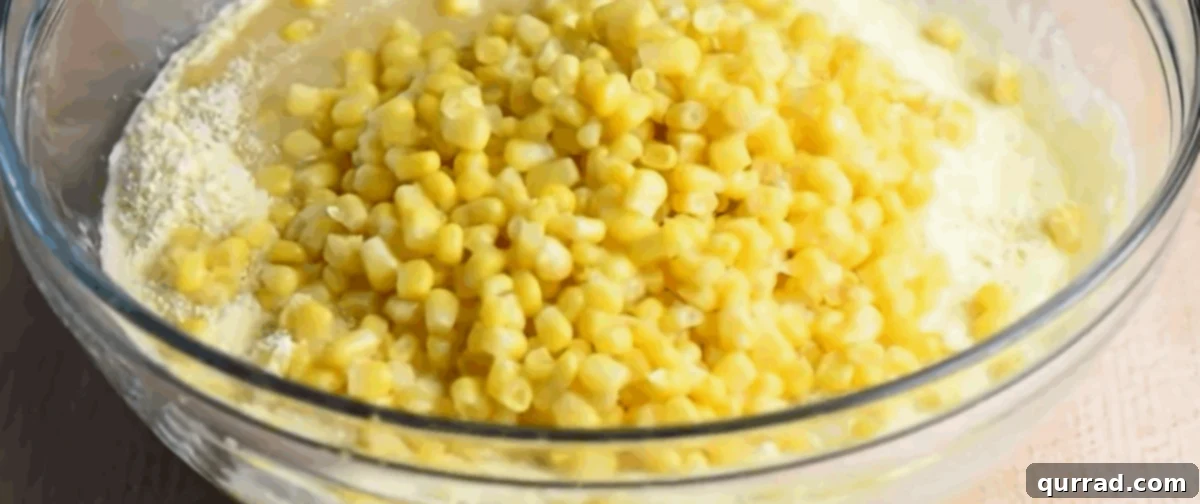 Ingredients for cornbread casserole in a glass bowl.
