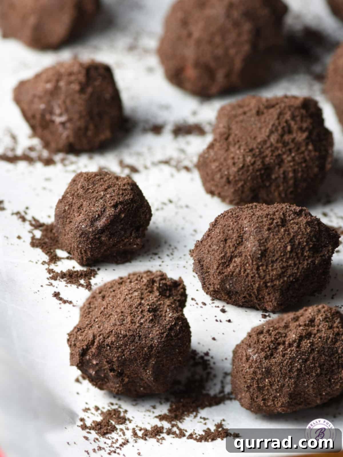 Black Diamond Krispie Treats 2 Delicious Lumps of Coal Rice Krispie Treats on parchment paper, ready for Christmas stockings