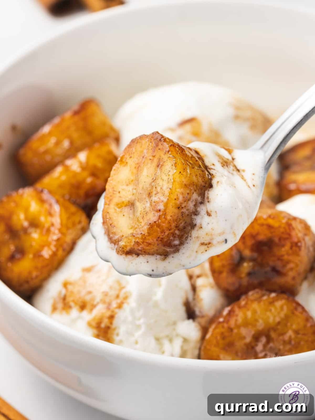 Golden Caramelized Bananas 7 Bowl of fried bananas topped with vanilla ice cream, ready to be served.