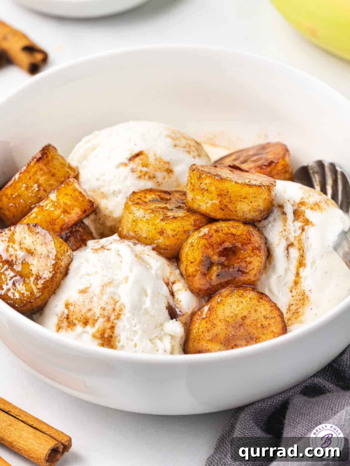 Golden Caramelized Bananas 6 Fried bananas soaking in a cinnamon brown sugar glaze in a skillet.
