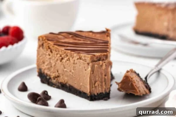a slice of chocolate cheesecake on plate with bite on fork