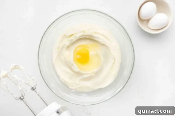 beaten cream cheese and sugar with egg in mixing bowl