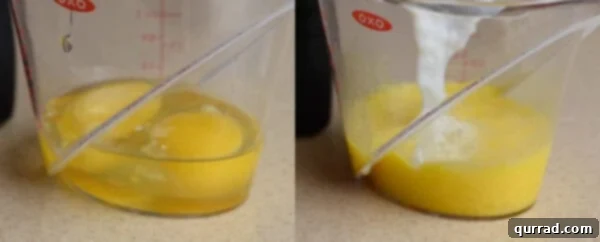 Hot tapioca pudding mixture being slowly whisked into beaten eggs in a measuring cup for tempering.