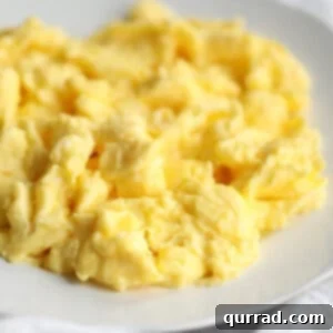 close up of fluffy scrambled eggs on plate