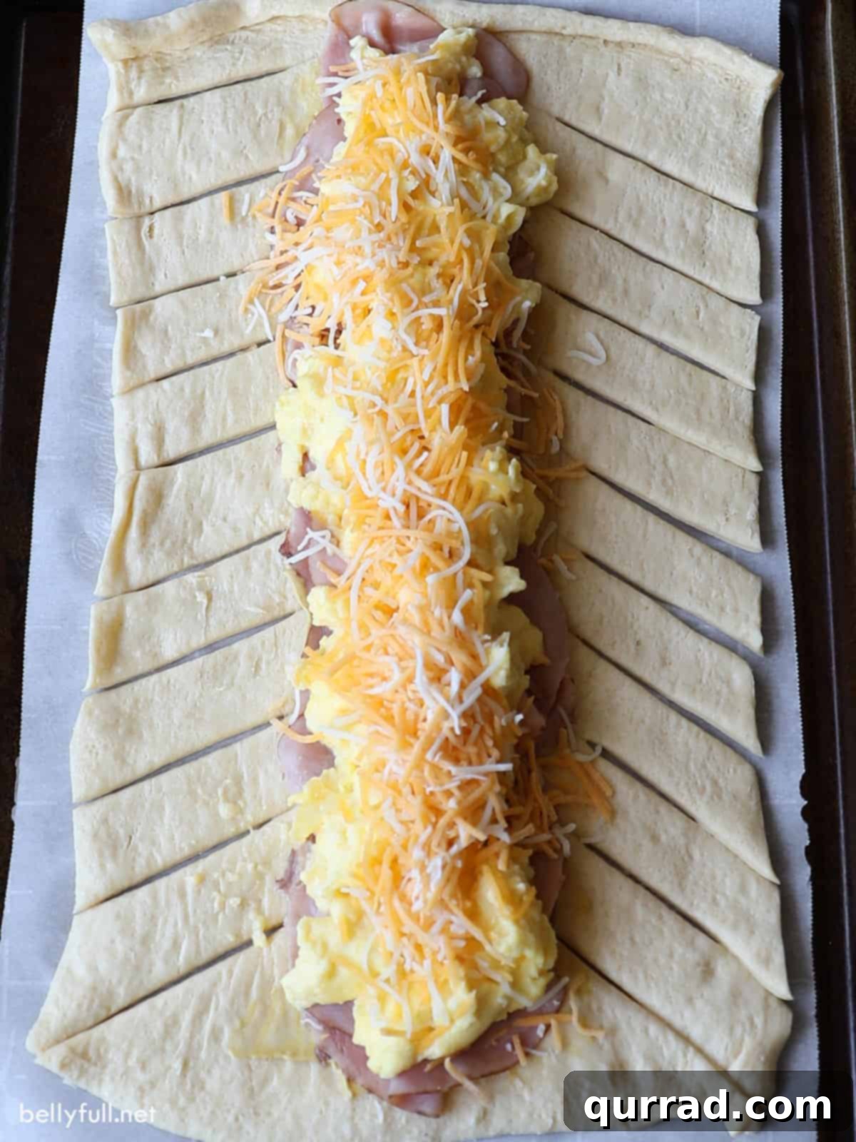 Effortless Morning Braid 4 assembled breakfast braid showing filling of eggs, cheese, and ham before baking