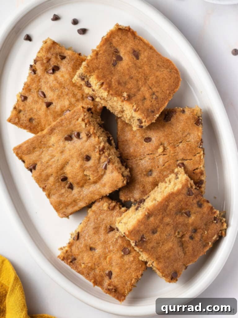One-Pan Banana Dream 2 cut banana cake squares overlapping on white serving plate
