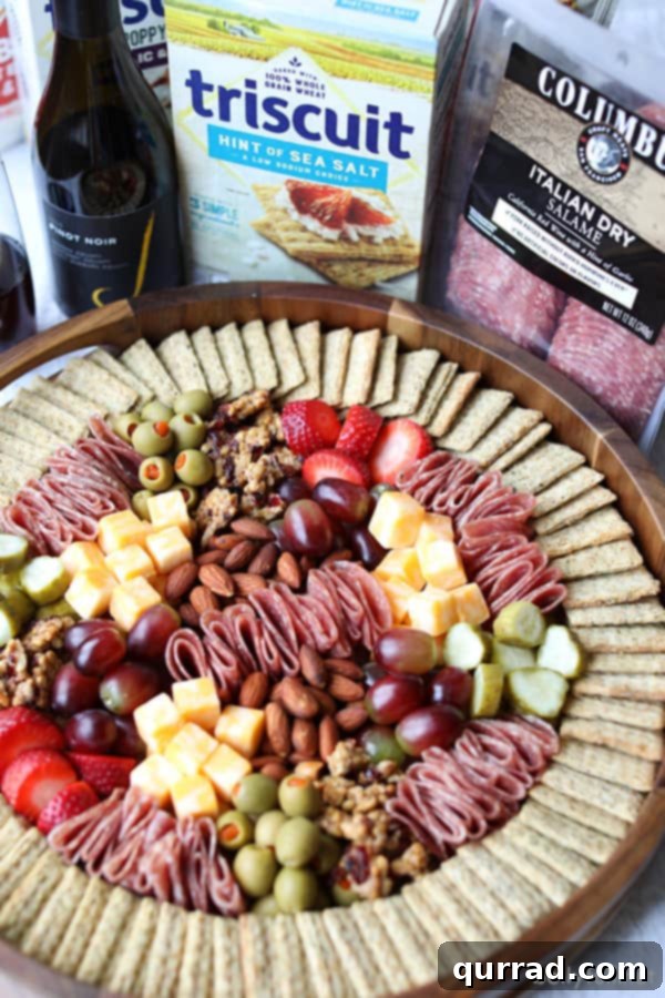 Discover the Best Ingredients for Your Charcuterie Board: Meats, Cheeses, and More Charcuterie Board featuring Columbus salami, Triscuit crackers, cheese, and fresh fruit