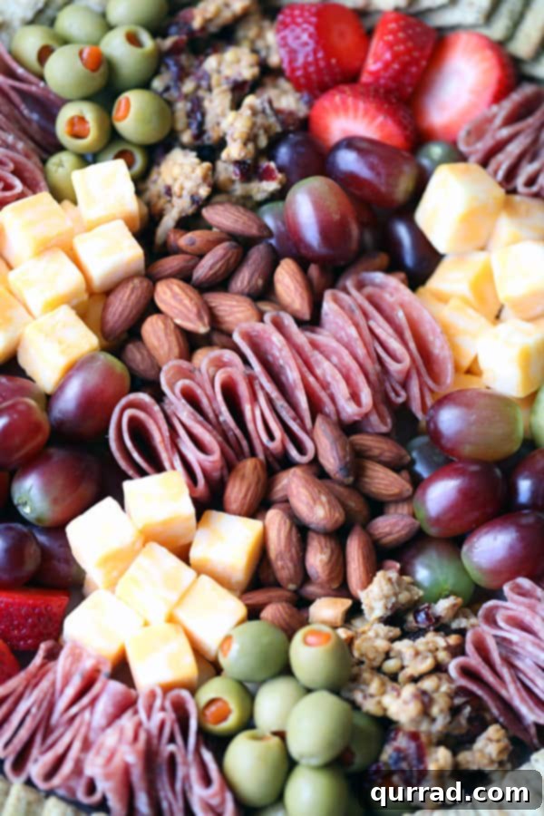 Charcuterie Board Ideas for Any Occasion: Holidays, Parties, and More Artfully arranged Charcuterie Board with salami, nuts, olives, and cheese