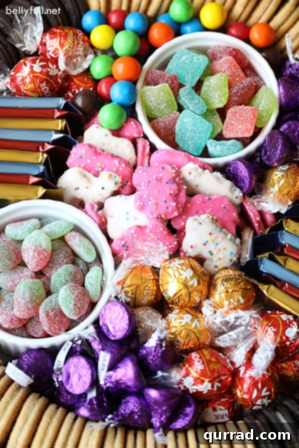 An enticing Dessert Charcuterie Board featuring a rich assortment of chocolates and vibrant candies. Close-up of a Dessert Charcuterie Board showcasing chocolate truffles, Hershey's Kisses, M&Ms, and other colorful candies
