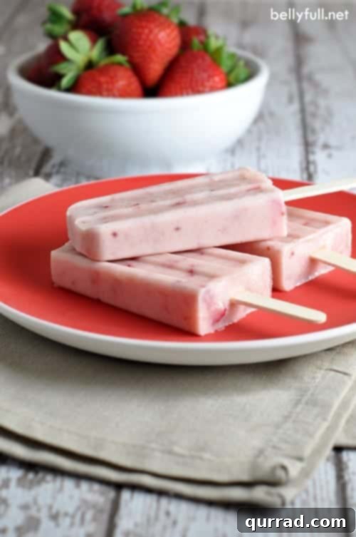 These Strawberry Jam Yogurt Pops are the best creamy strawberry popsicles with only 4 ingredients! Homemade Strawberry Jam Yogurt Pops: Creamy Strawberry Popsicles with Only 4 Ingredients!
