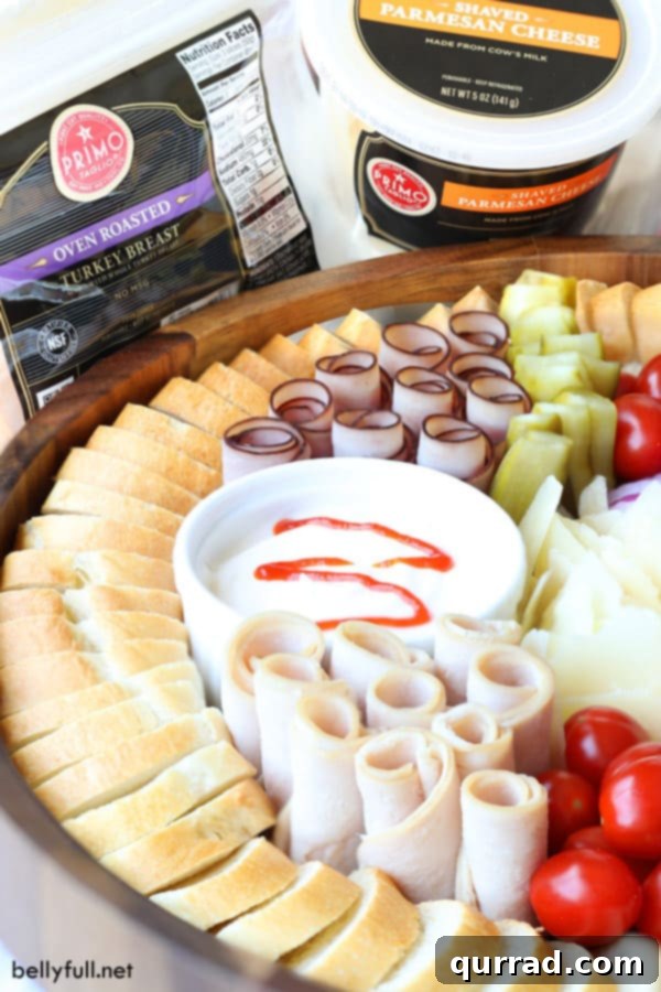 Build a beautiful Deli Sandwich Charcuterie Board with a variety of ingredients #CharcuterieBoard #DeliSandwichIdeas #PartyPlatter Deli Sandwich Charcuterie Board featuring premium meats and cheeses