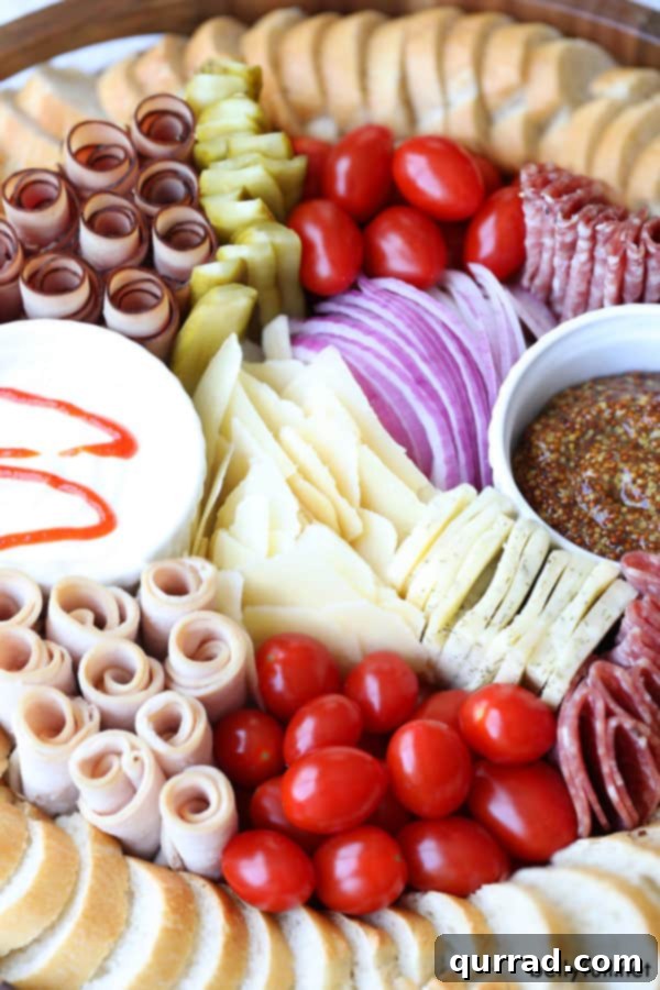 Inspiring close-up of a Mini Deli Sandwich Charcuterie Board - perfect for any event #CharcuterieBoard #PartyFoodIdeas #Gourmet Mini Deli Sandwich Charcuterie Board close-up showing fresh ingredients