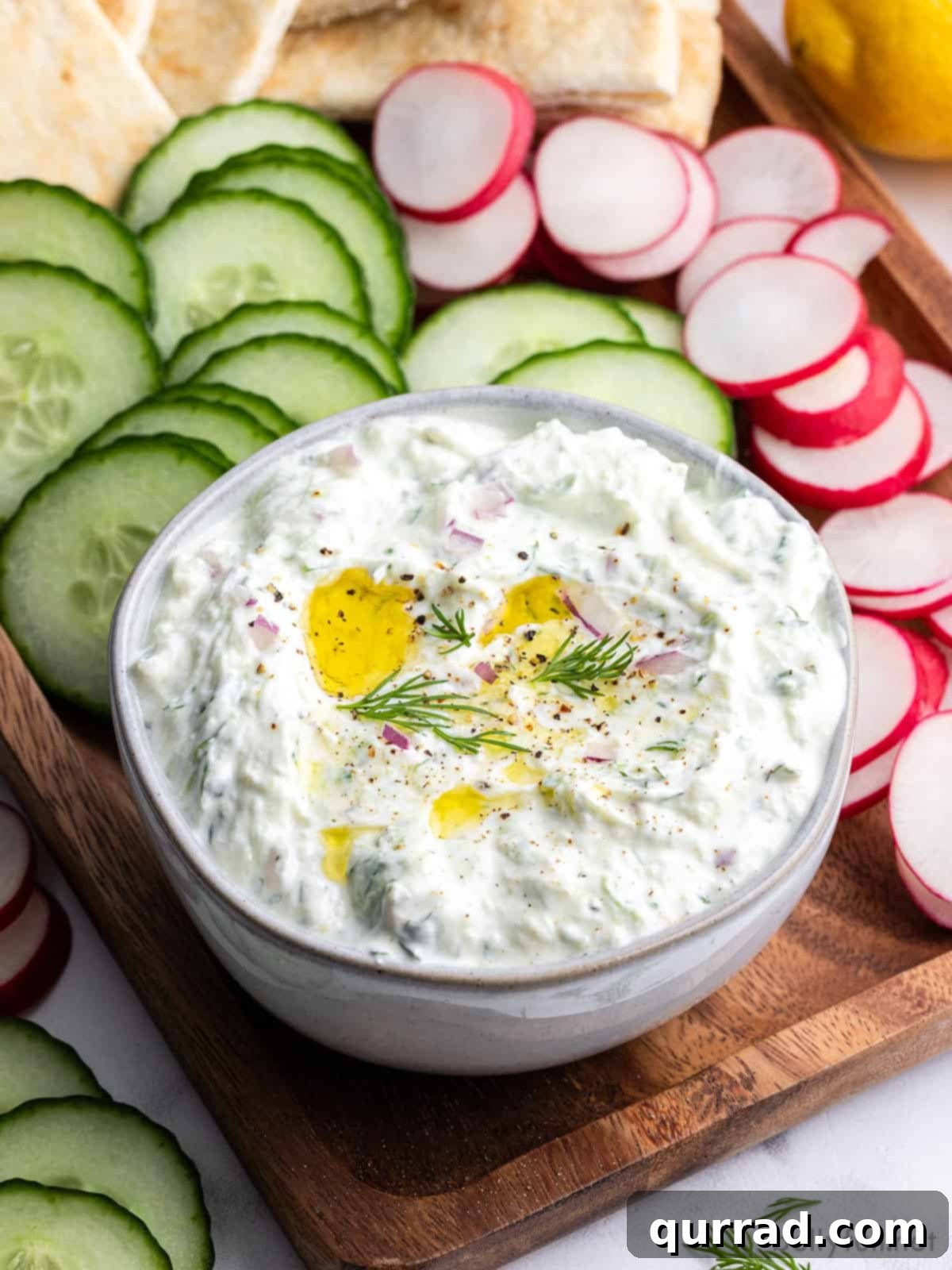 Refreshing Greek Cucumber Yogurt Dip 2 A vibrant bowl of homemade Tzatziki sauce, garnished with fresh mint and a drizzle of olive oil, ready to be enjoyed.