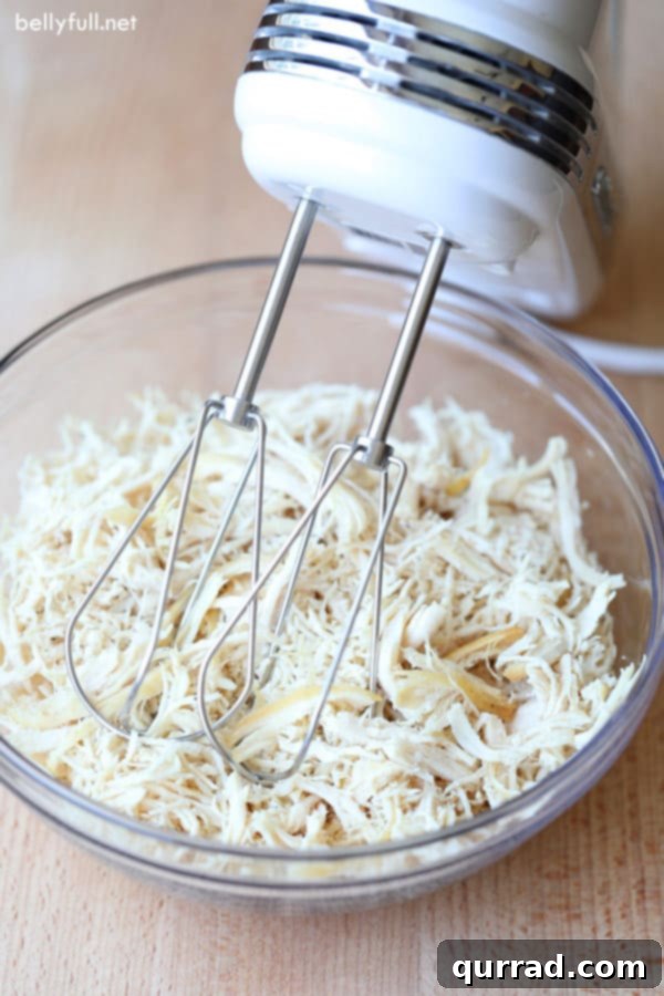 Smart Kitchen Secrets 8 Shred cooked chicken quickly and easily using a handheld electric mixer for meal prep.