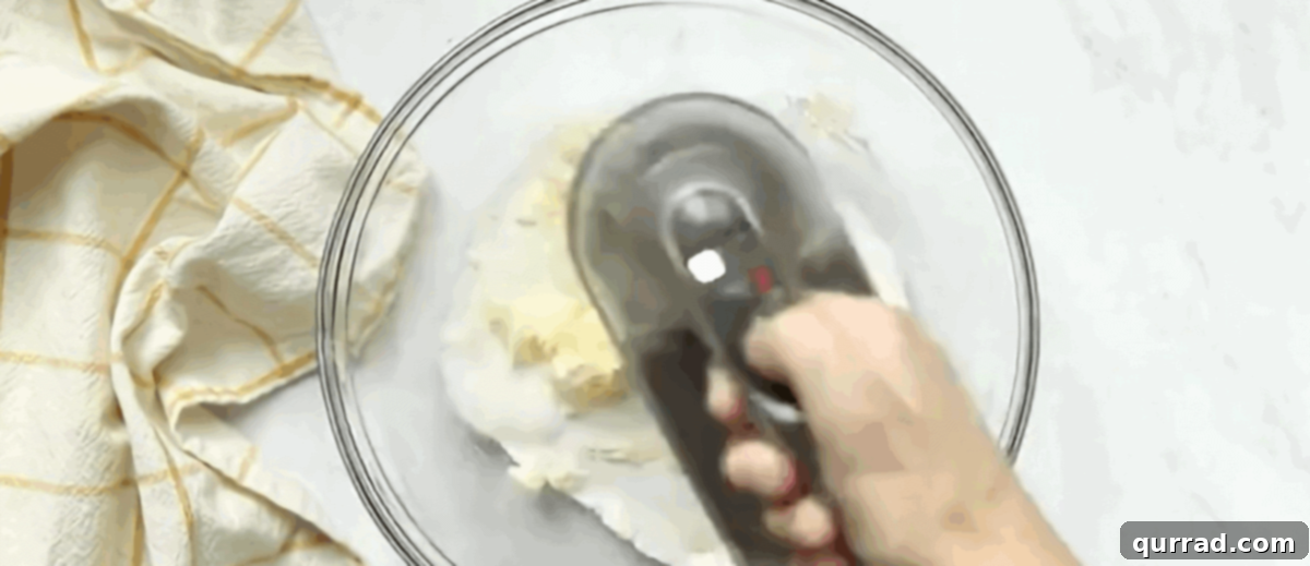 Vibrant Fruit Pizza 4 Creaming butter and sugar with a handheld mixer until light and fluffy.