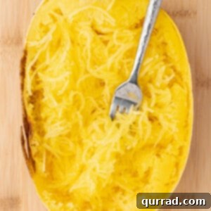 Half of a spaghetti squash roasted with pulled strands